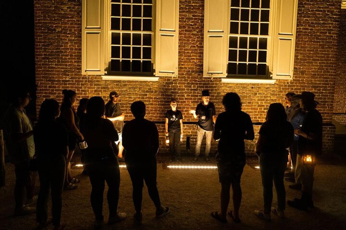 a group of people standing in front of a building at night