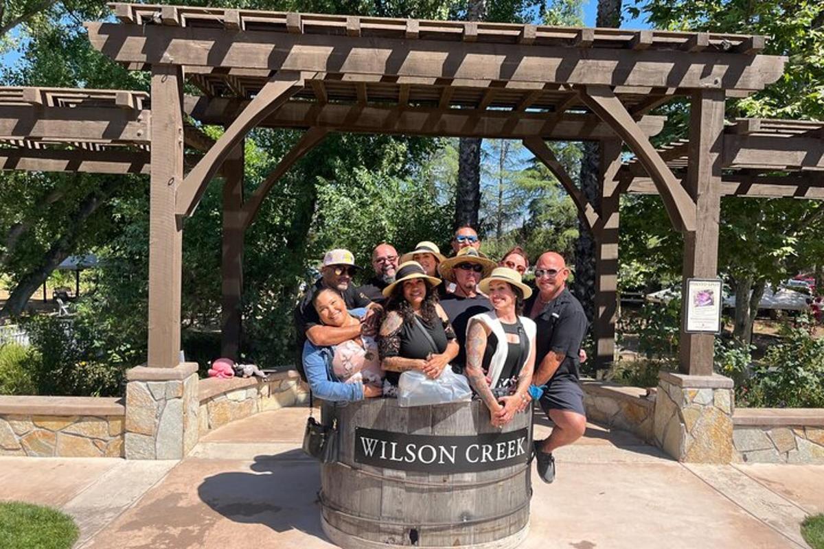 a group of people posing for a picture in a barrel