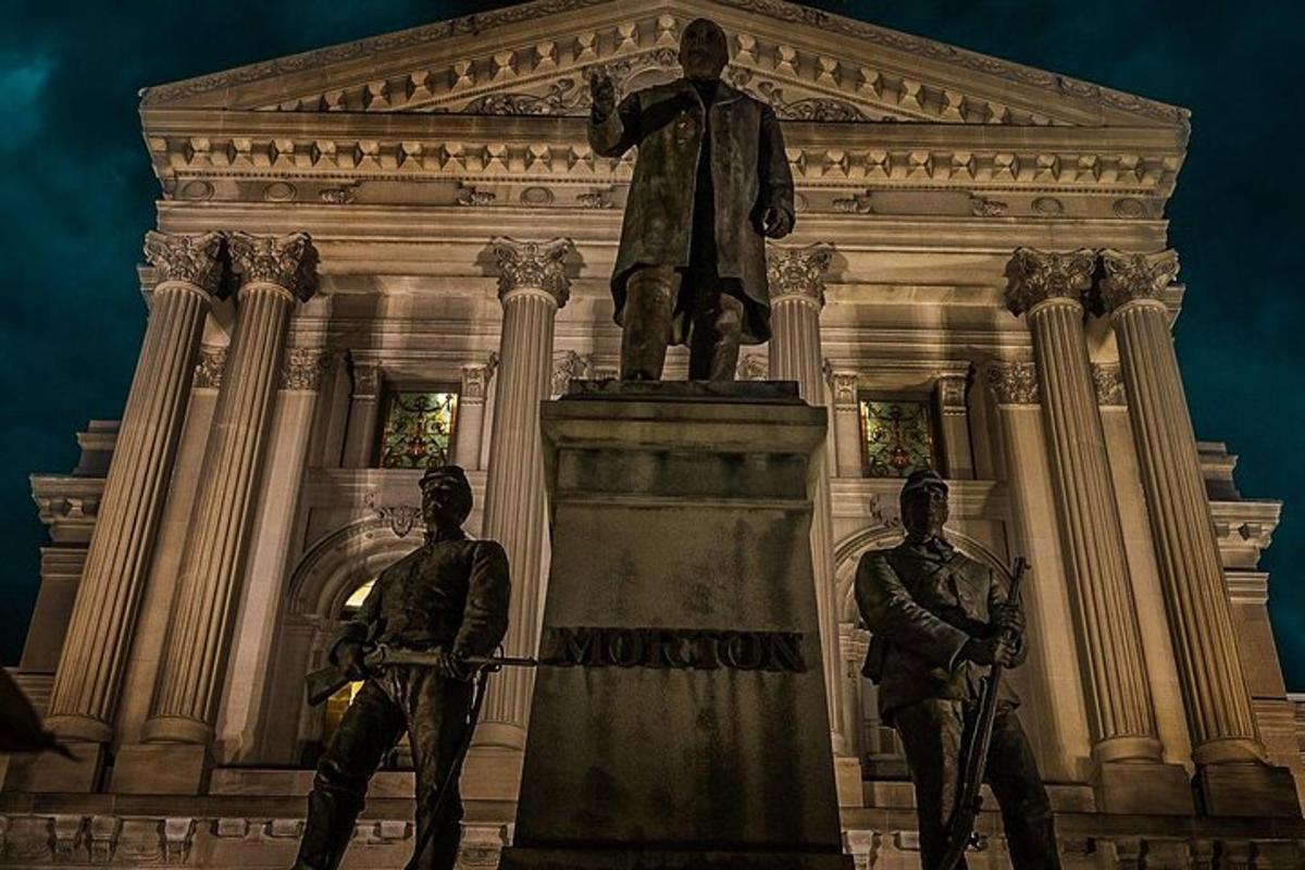 a statue of a man standing in front of a building
