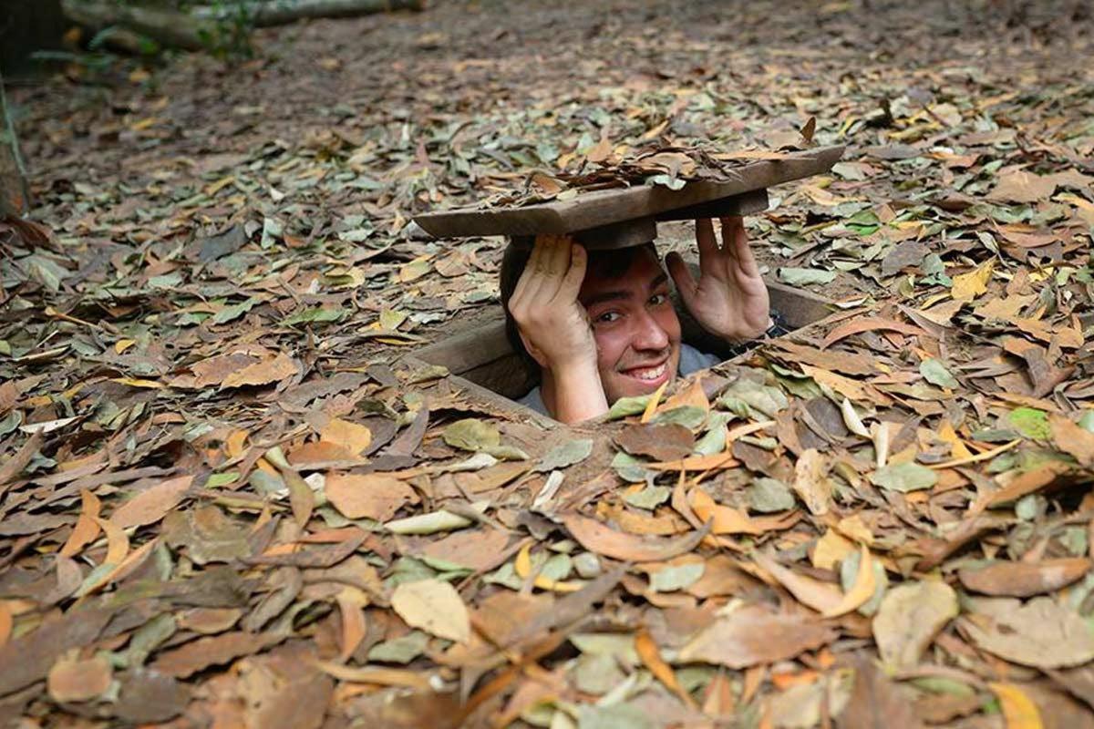 a man is poking his head out of a pile of leaves