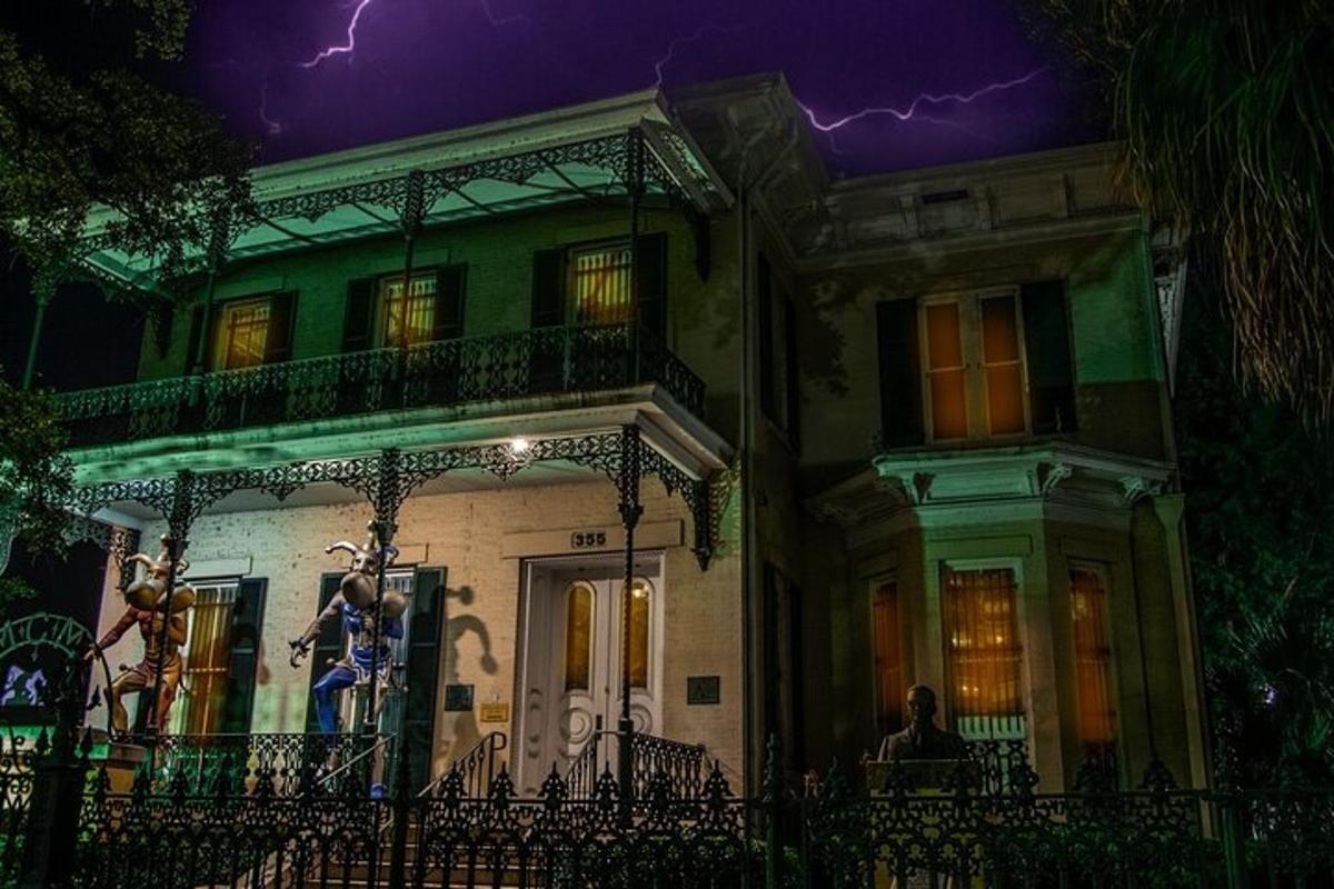 a house with lightning in the sky behind it