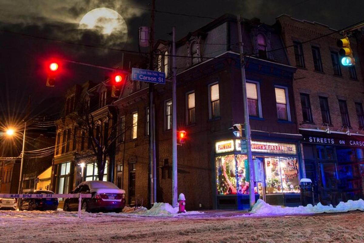 a street corner with a traffic light and a store