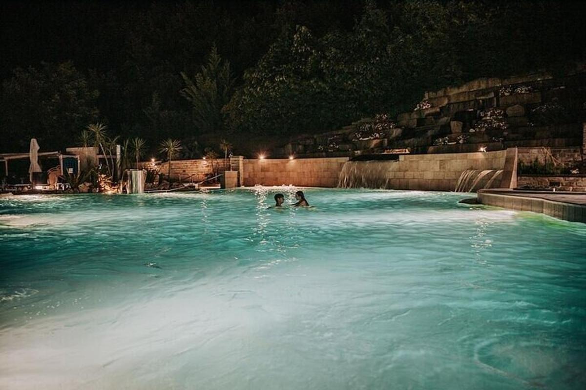 una persona che nuota in una piscina di notte