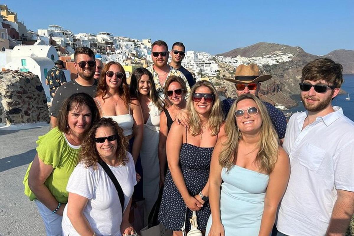 a group of people posing for a picture on top of a city