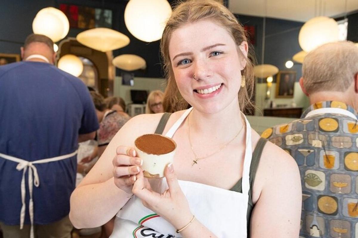 a woman is smiling while holding a cup of coffee