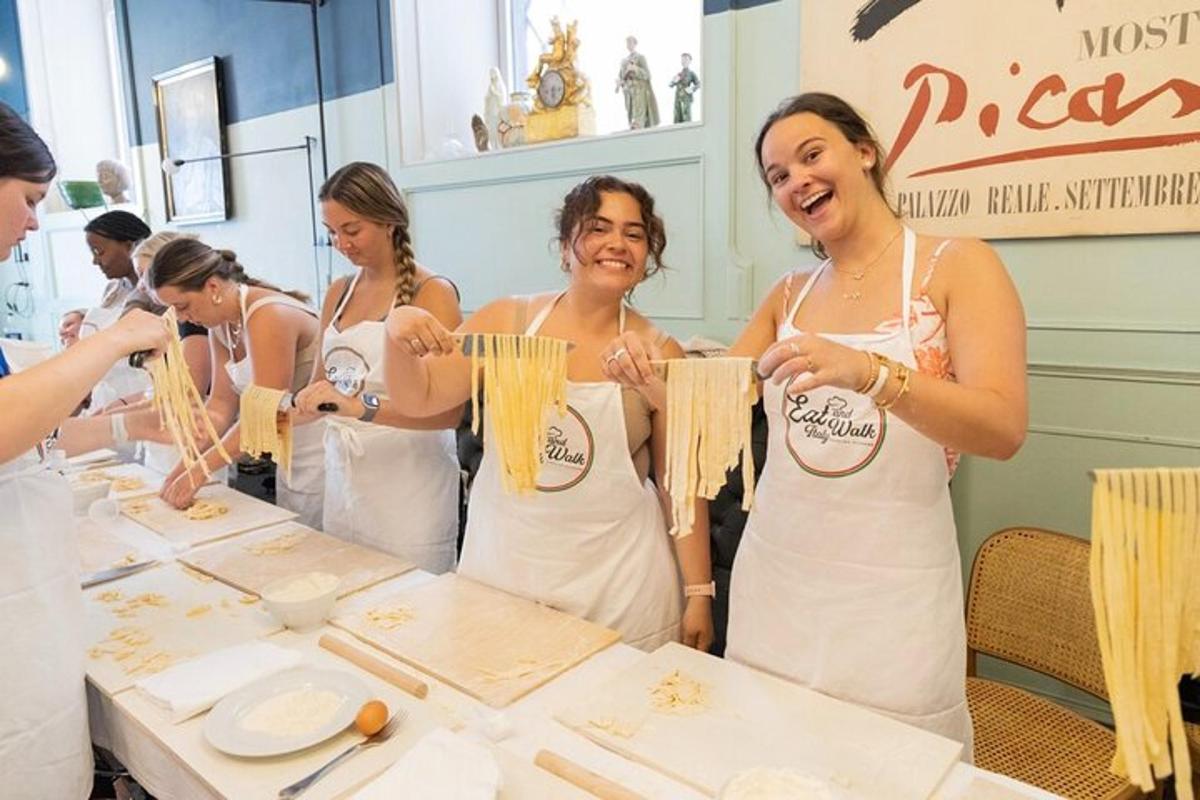 a group of women standing around a table preparing food