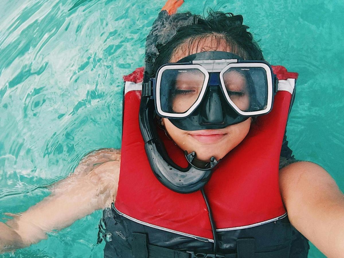 una dona en una piscina amb tub i ulleres
