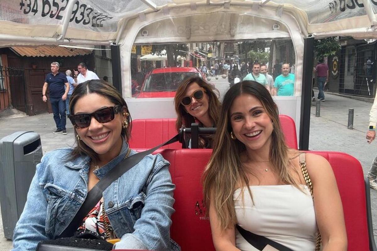 three women are sitting on a bus
