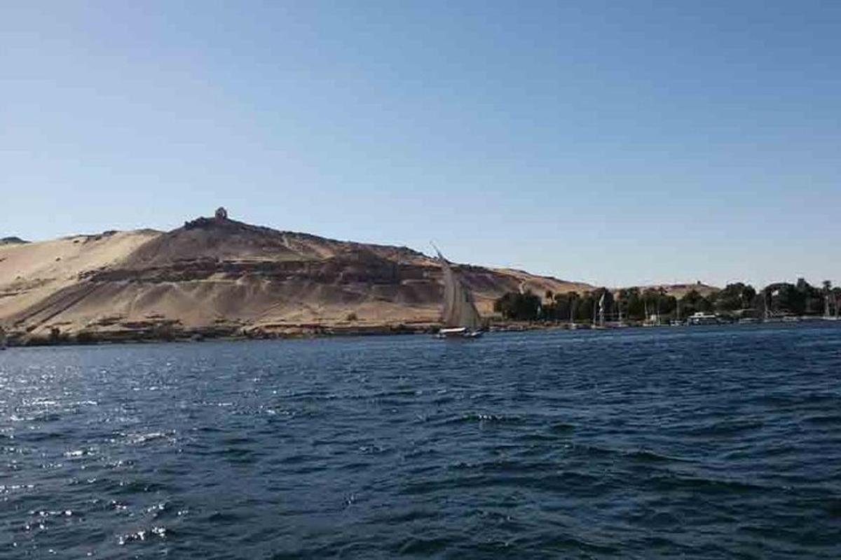 a large body of water with a mountain in the background