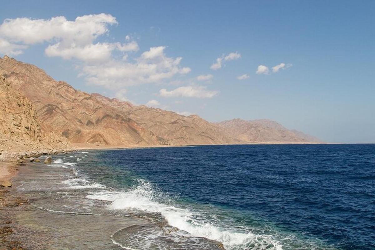 a view of the ocean with mountains in the background