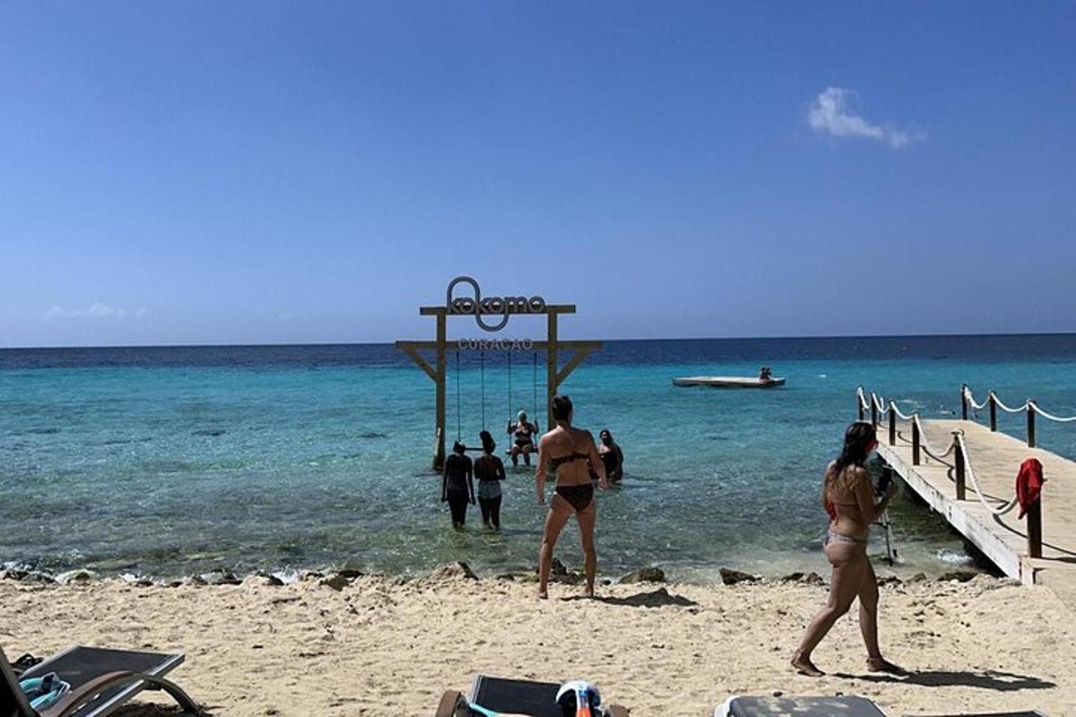 a group of people playing volleyball on the beach