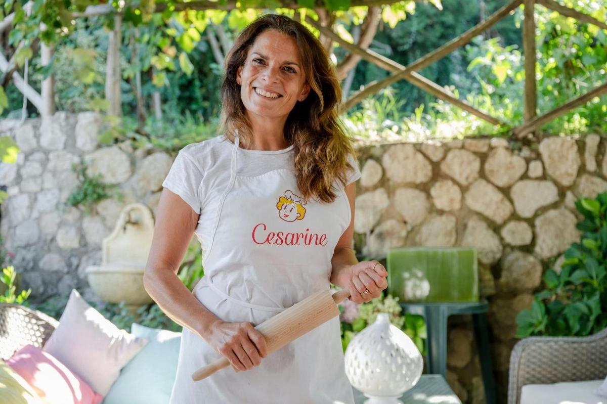 una donna che tiene in mano un mattarello in un giardino