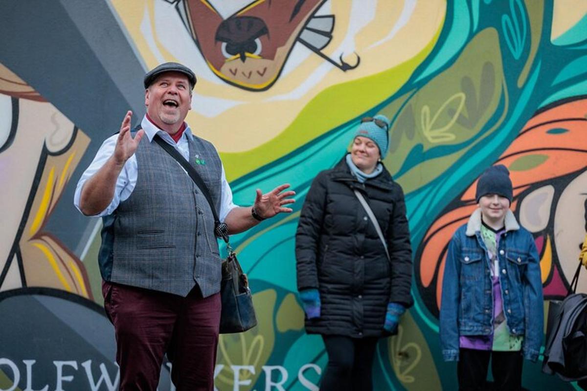 a man and two women standing in front of a wall