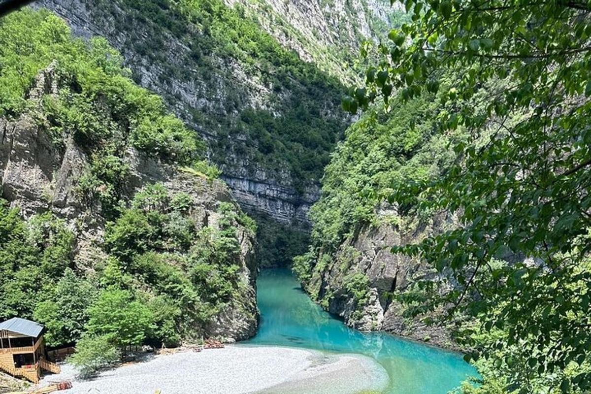 a river in the middle of a mountain with green water