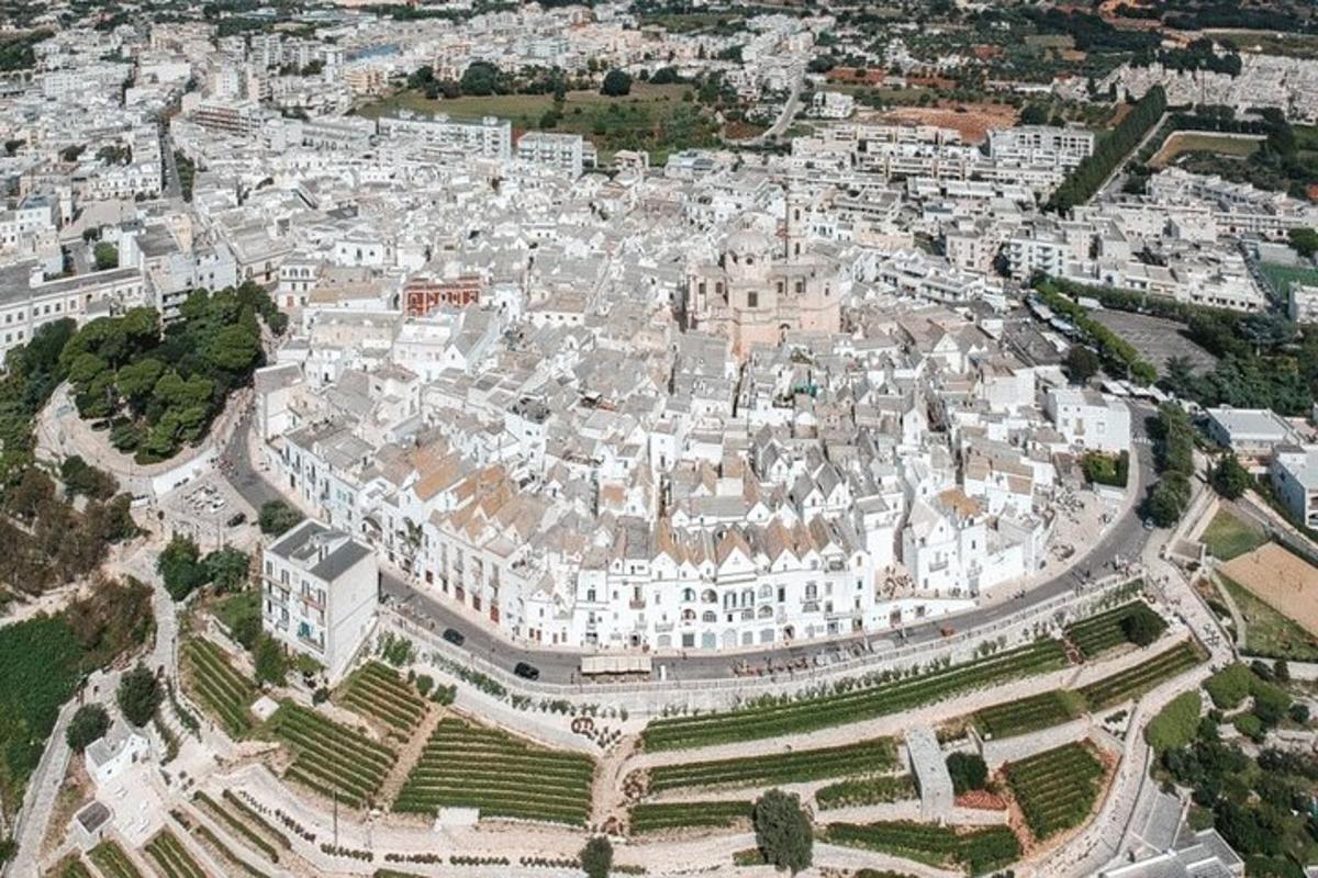 an aerial view of a city with white buildings