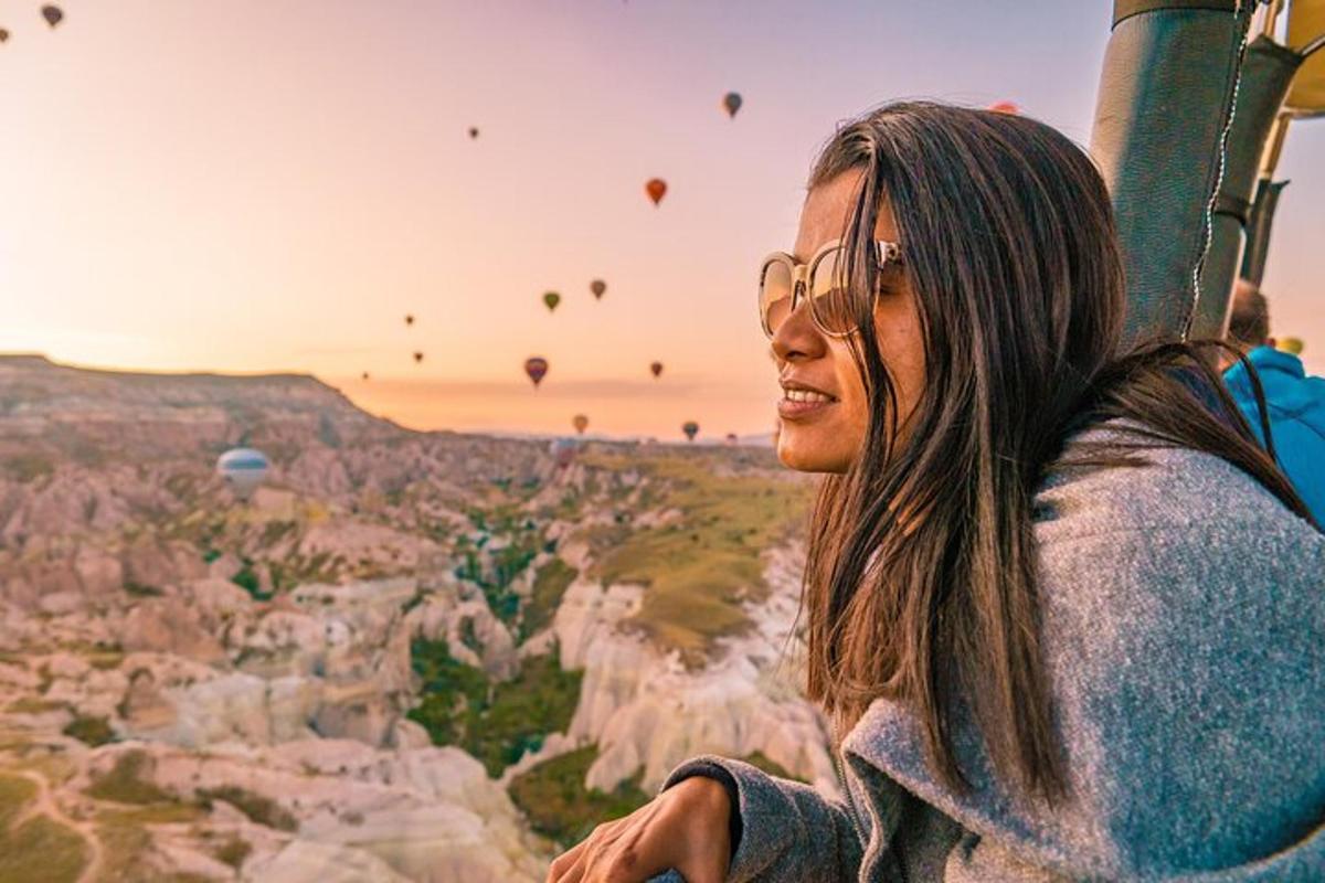 a woman in glasses looking at hot air balloons