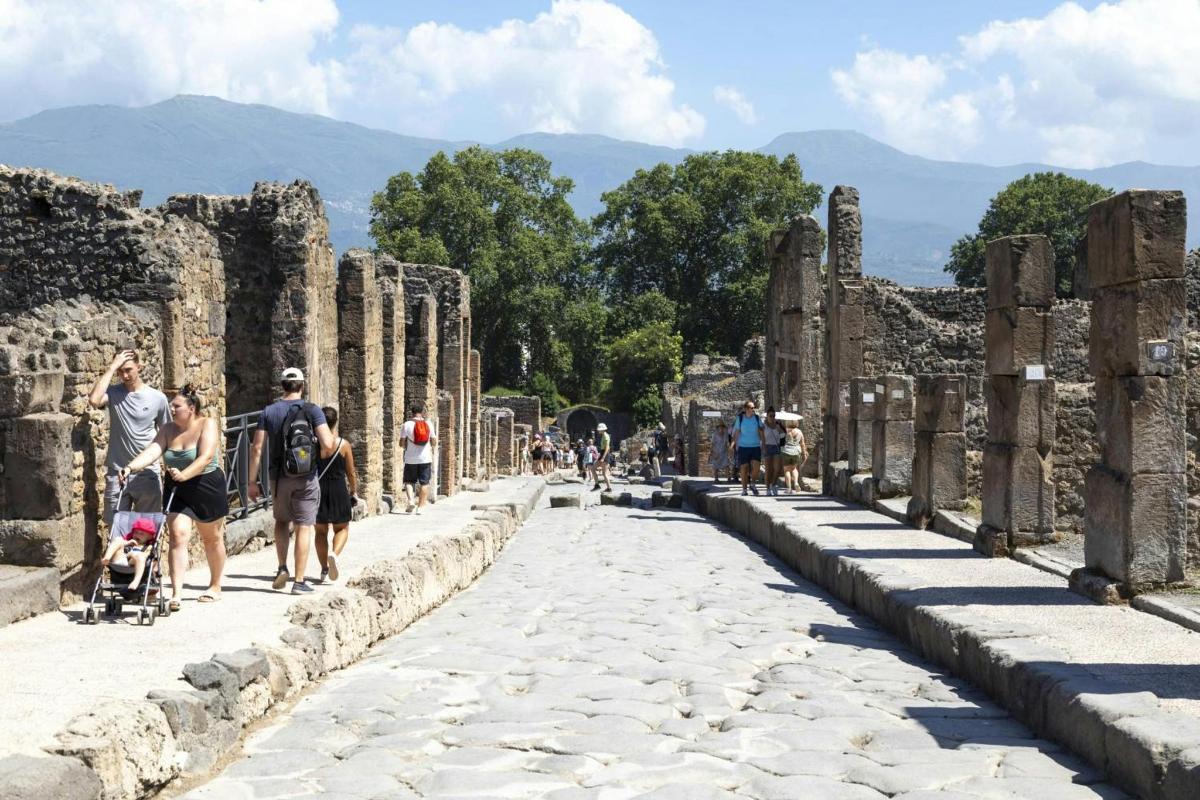 people walking down a street in the ruins