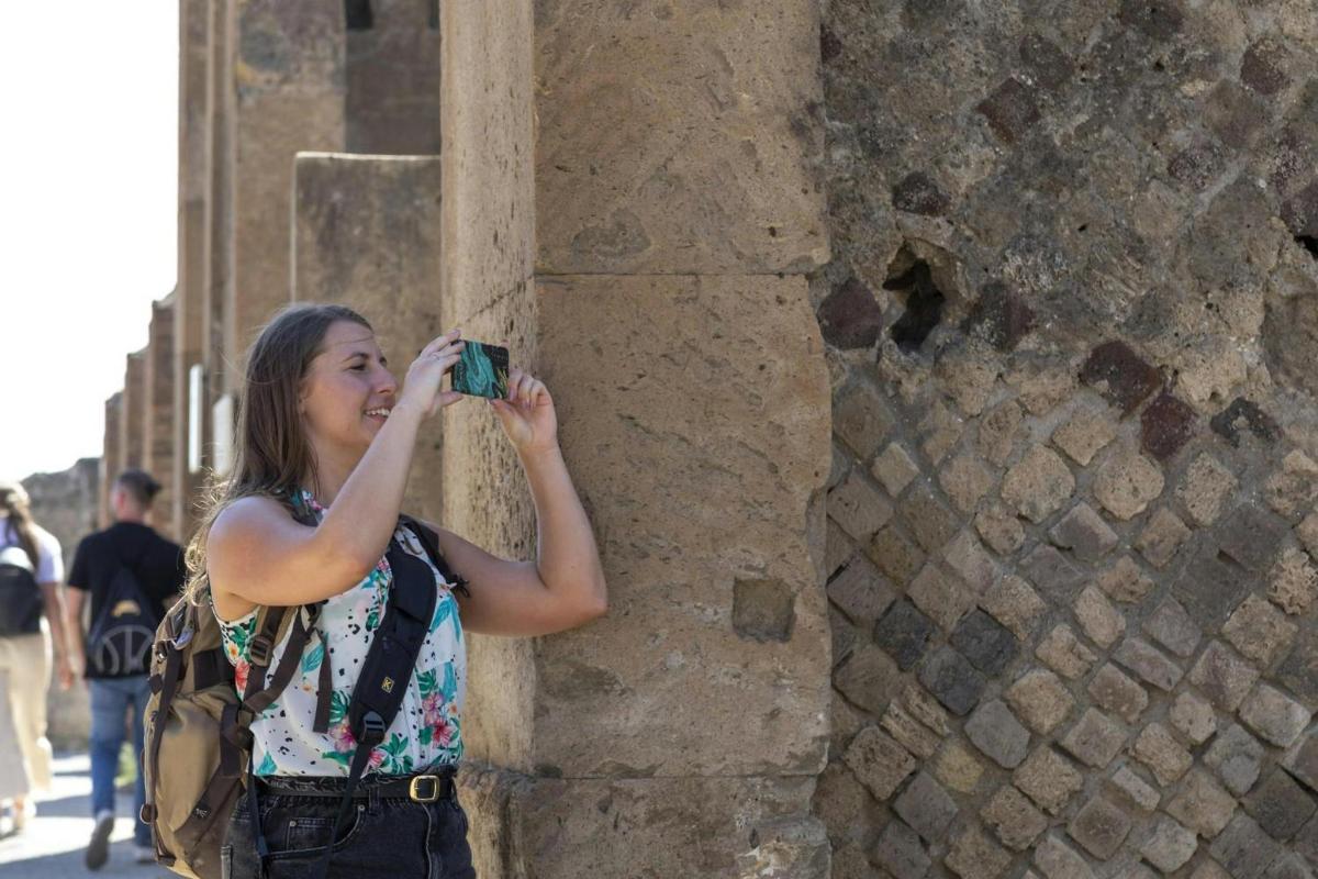 a woman taking a picture of a building