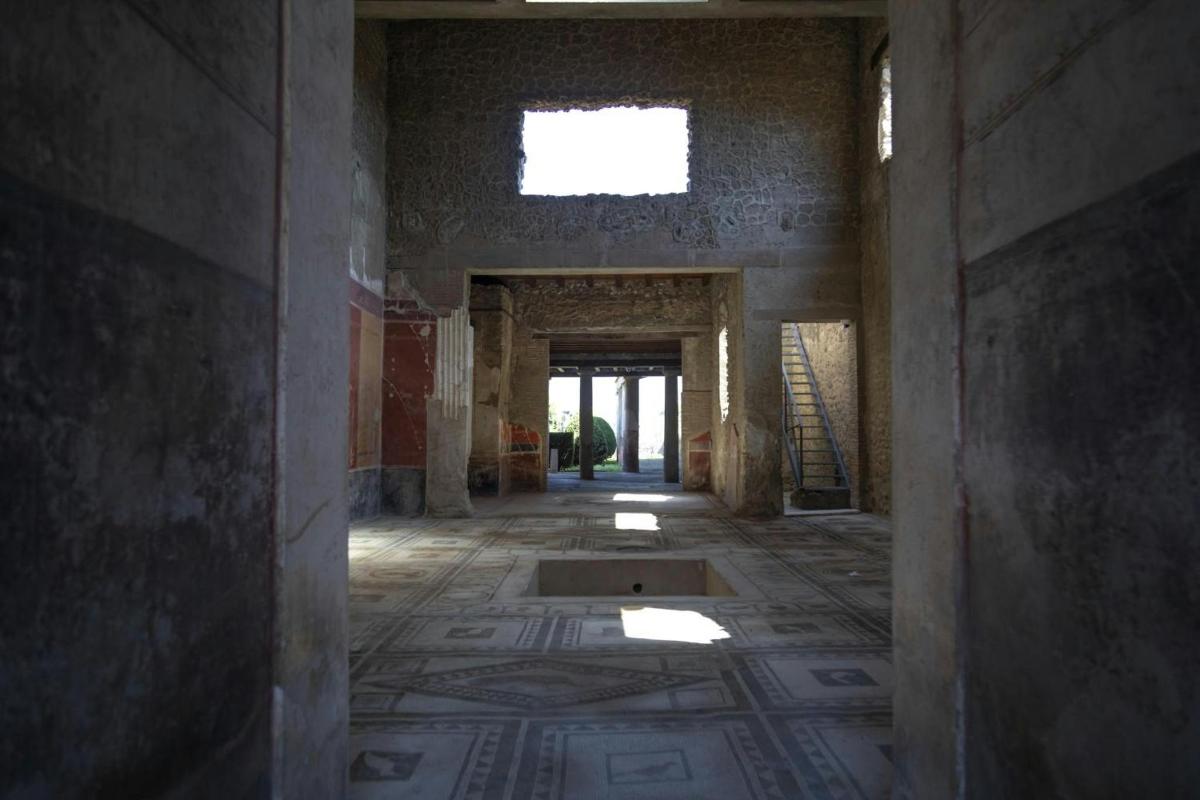 an empty room with a tile floor and a window