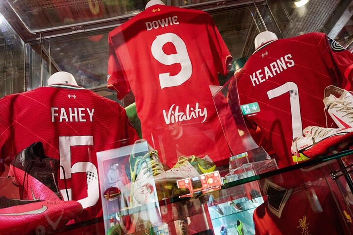 three red jerseys in a display case in a store