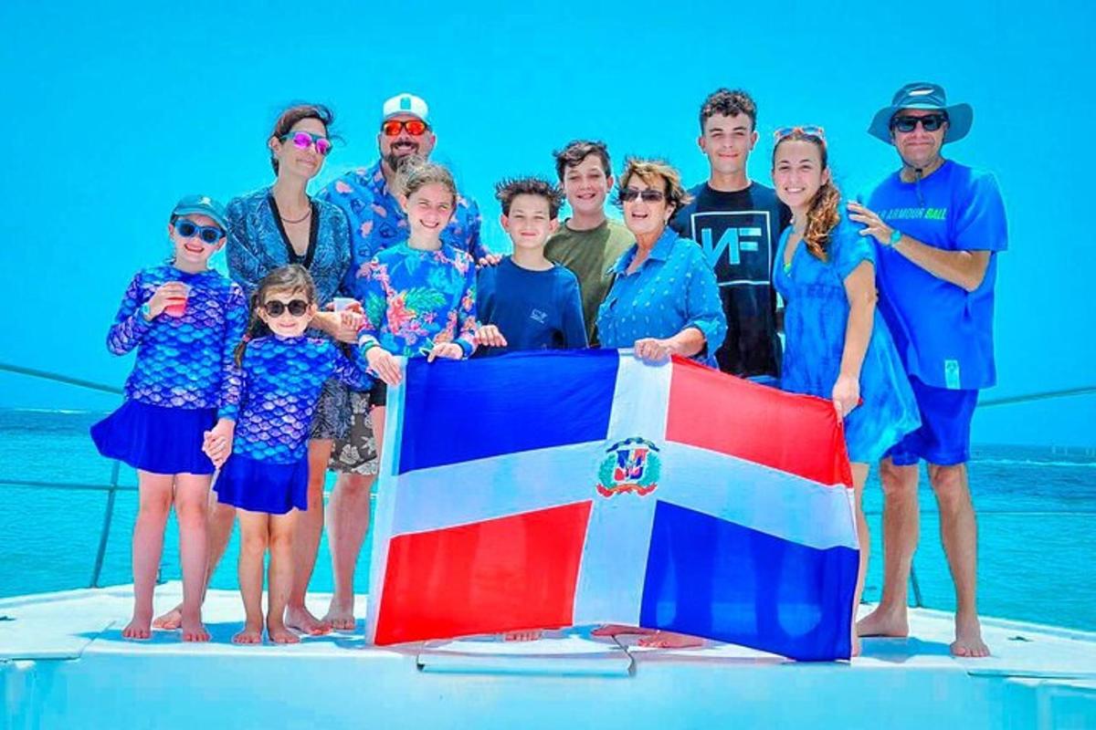a group of people standing on a boat with a flag