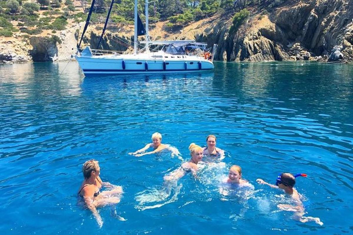 un grup de persones a l'aigua amb una barca