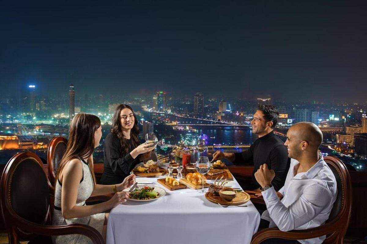 a group of people sitting around a table with food