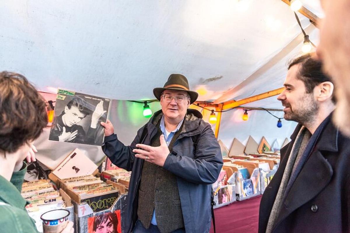 a man in a hat standing in a market