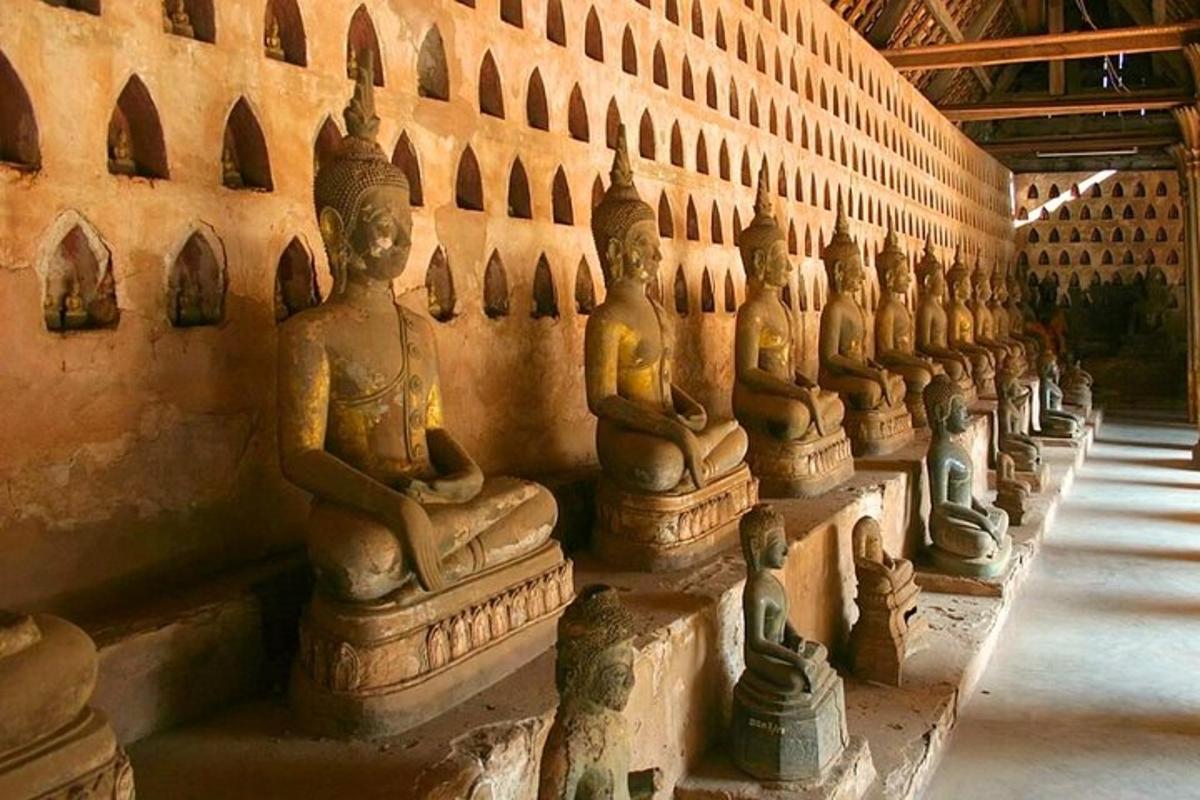 a row of statues on the side of a wall