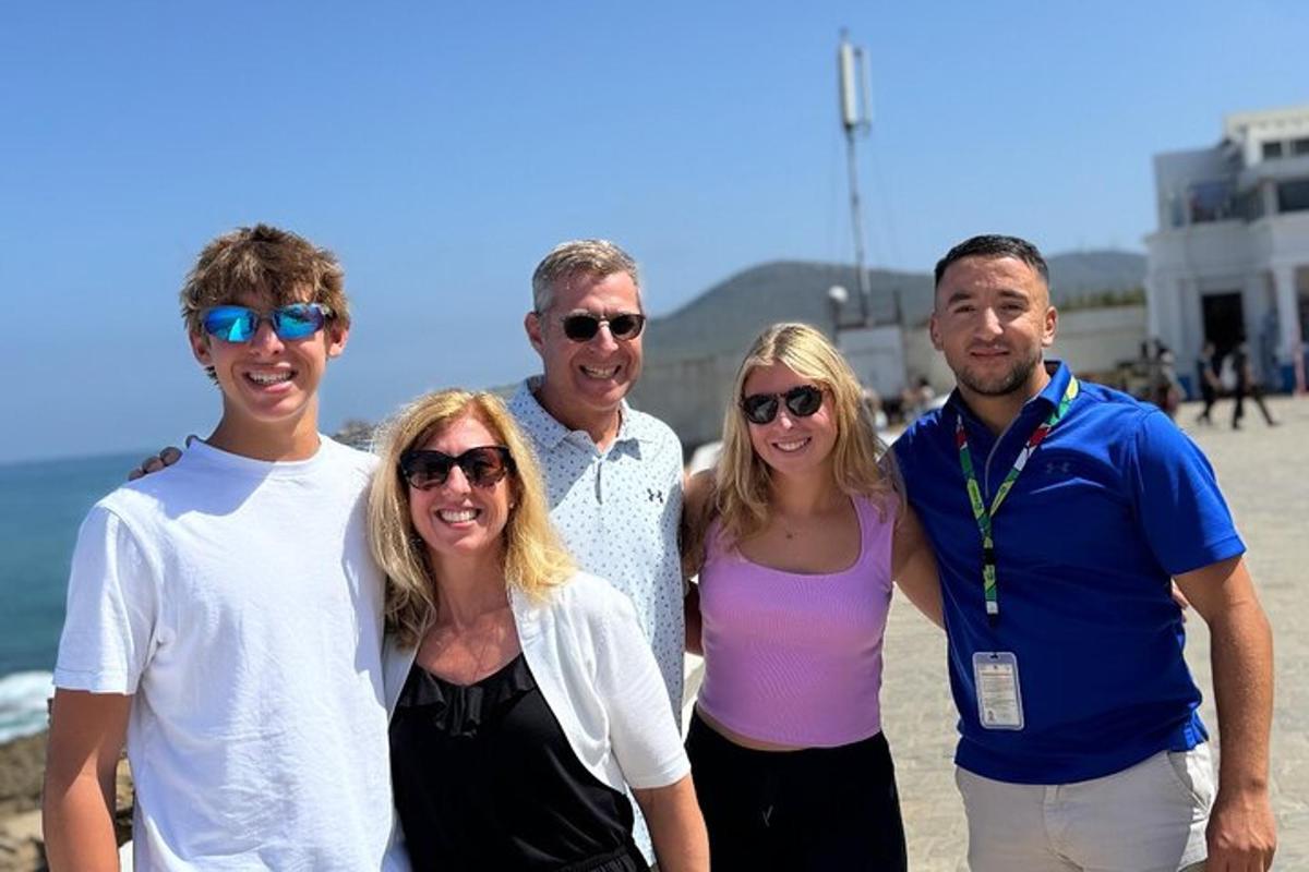 a group of people posing for a picture on the beach