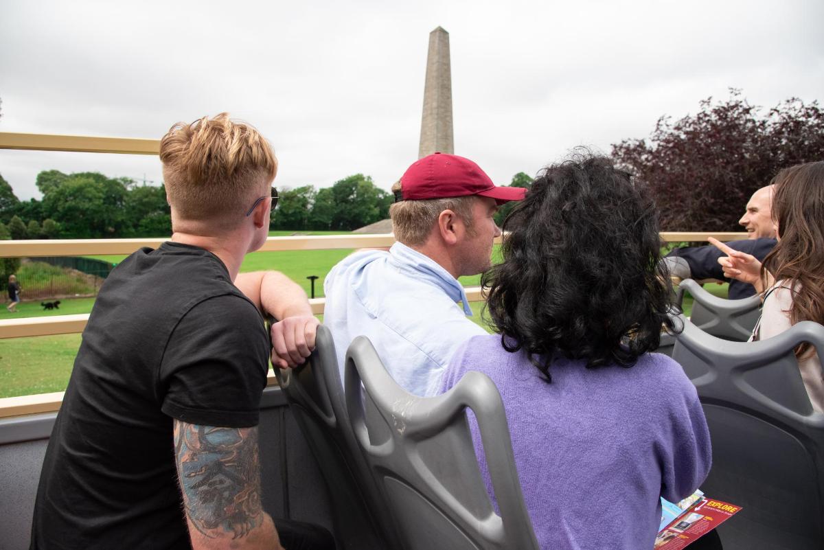 a group of people sitting in a seat looking at the eiffel tower