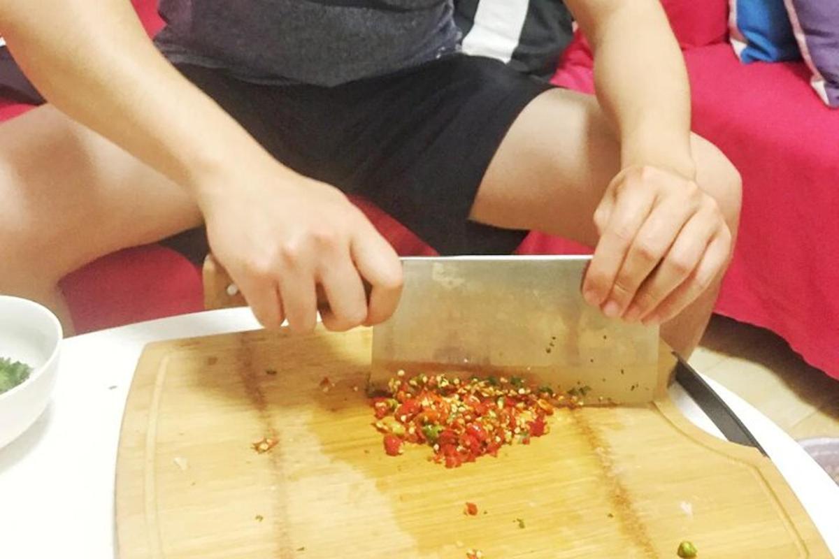 a person is cutting up food on a cutting board