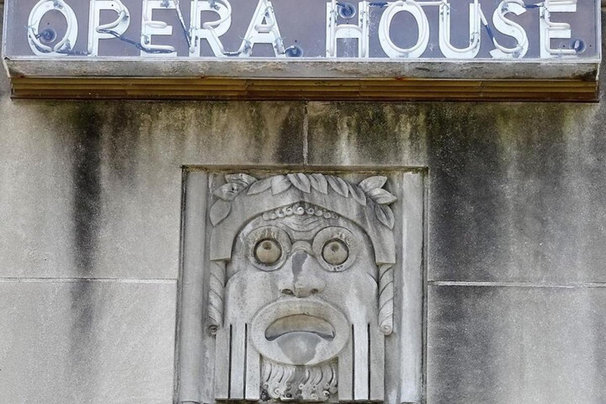 a sign on a building with a face on it