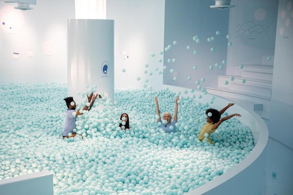 a group of children playing in a pool of balls