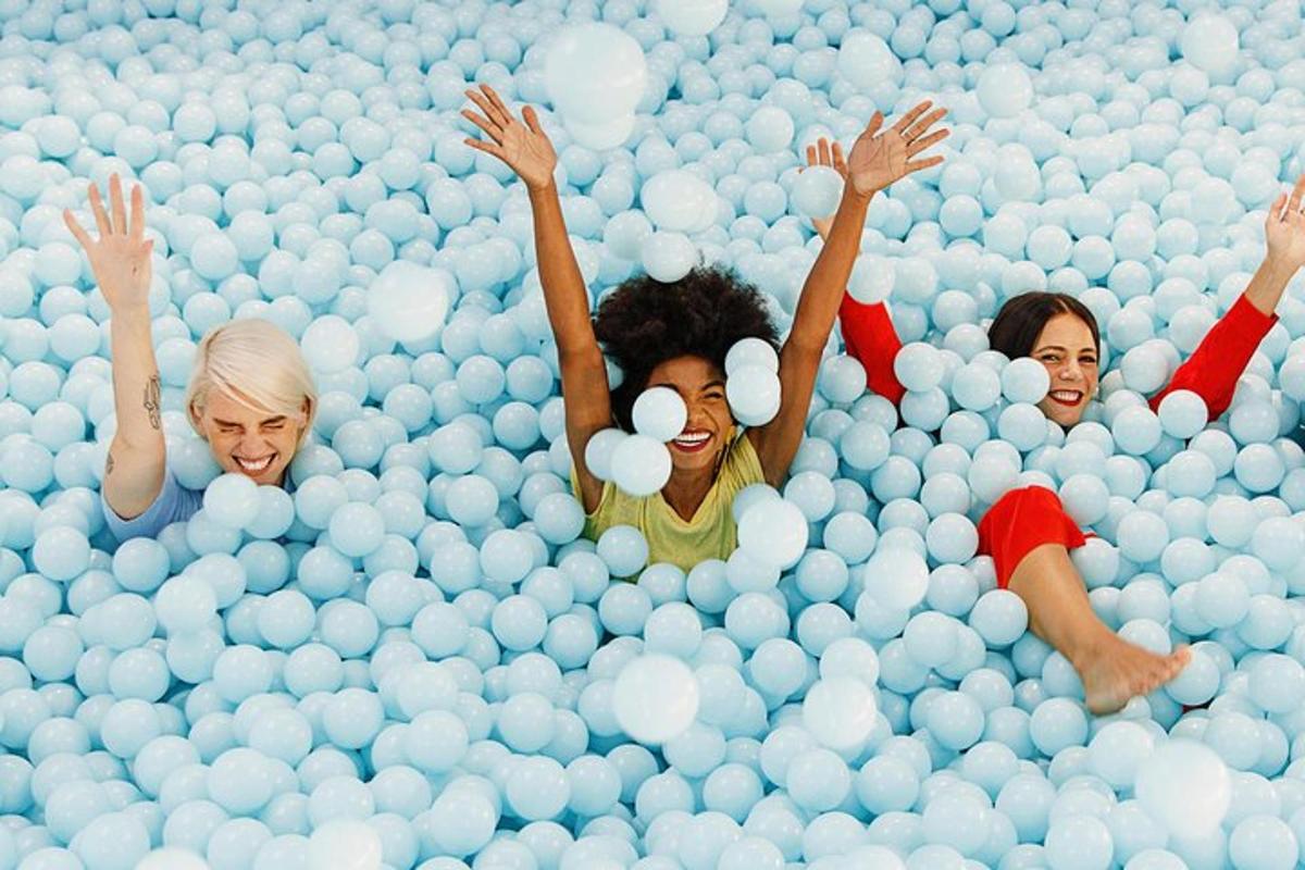 a group of people laying in a ball pool of balls