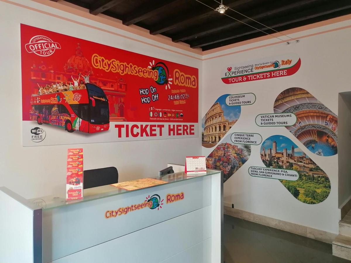 a ticket office with a red double decker bus on the wall
