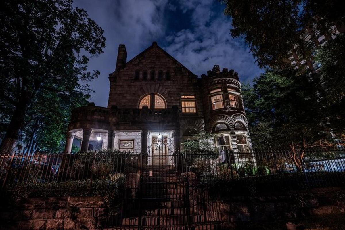 an old house with a fence in front of it