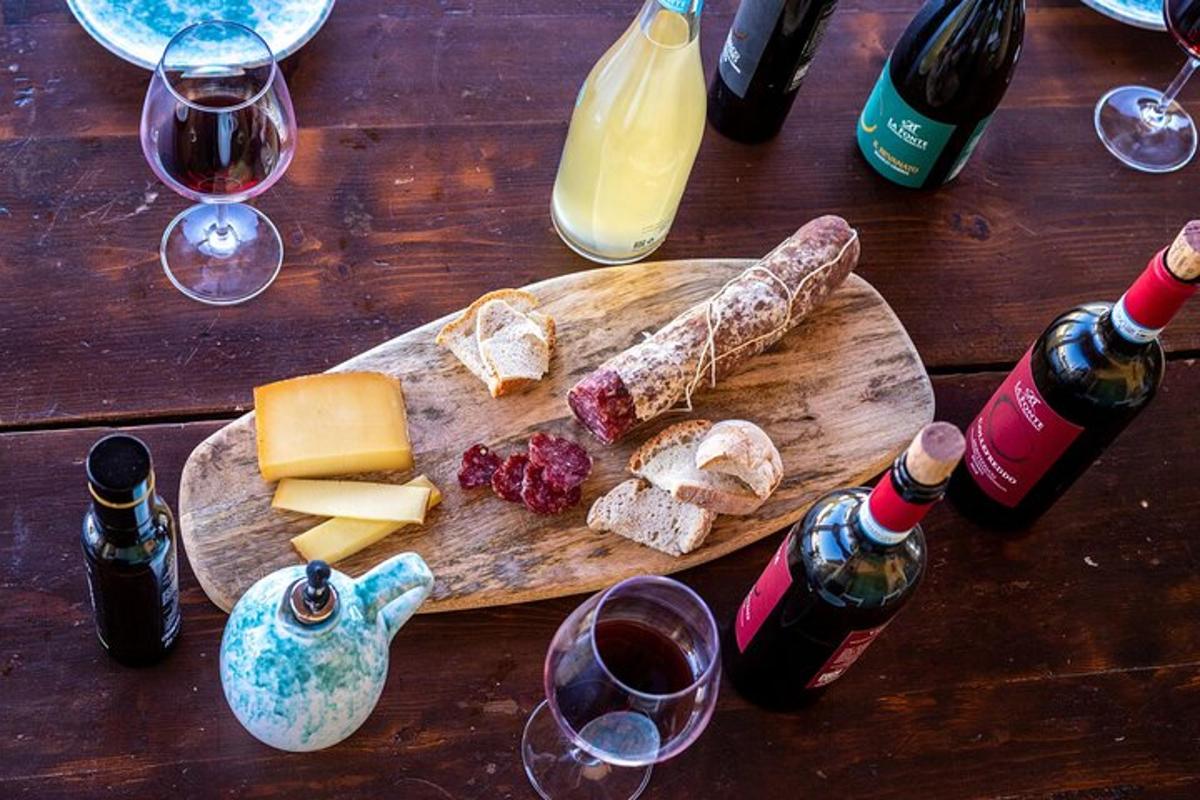 a wooden table with bottles of wine and cheese