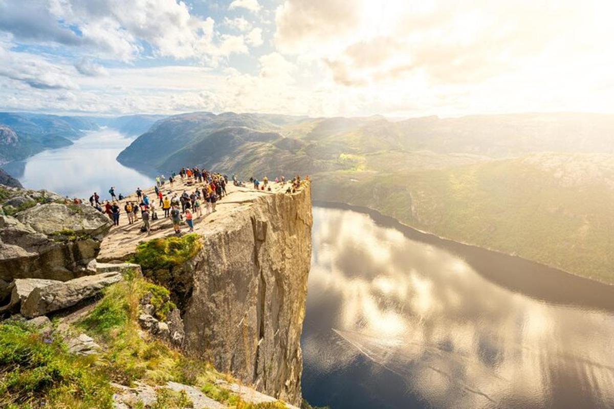 a group of people standing on the edge of a mountain