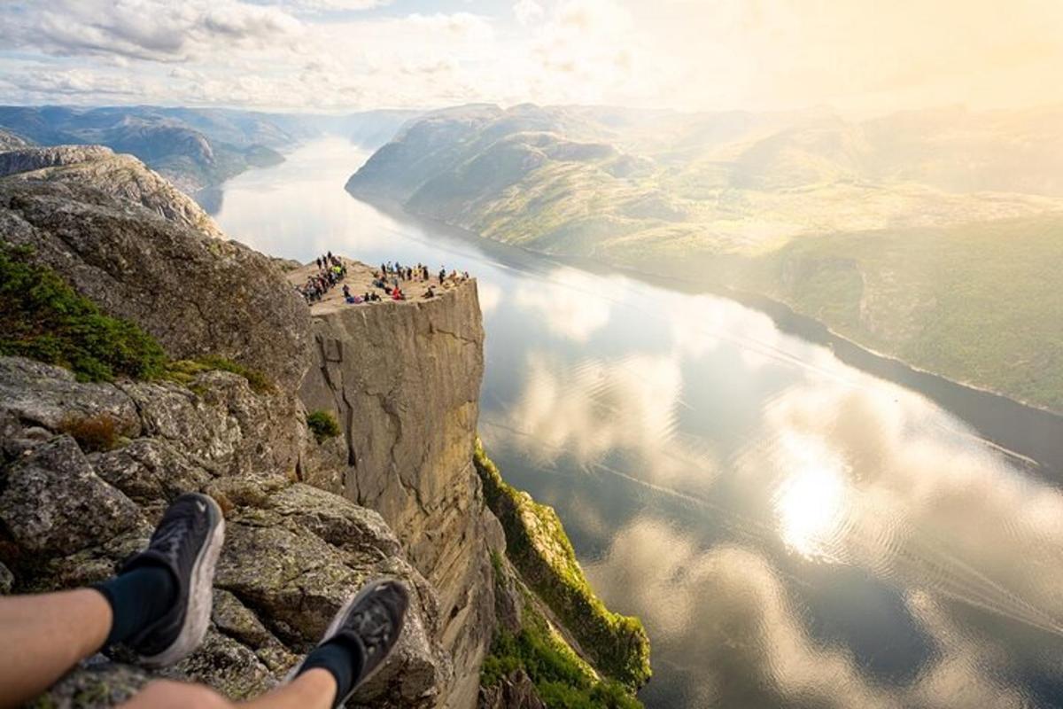 a person sitting on the edge of a cliff overlooking a canyon