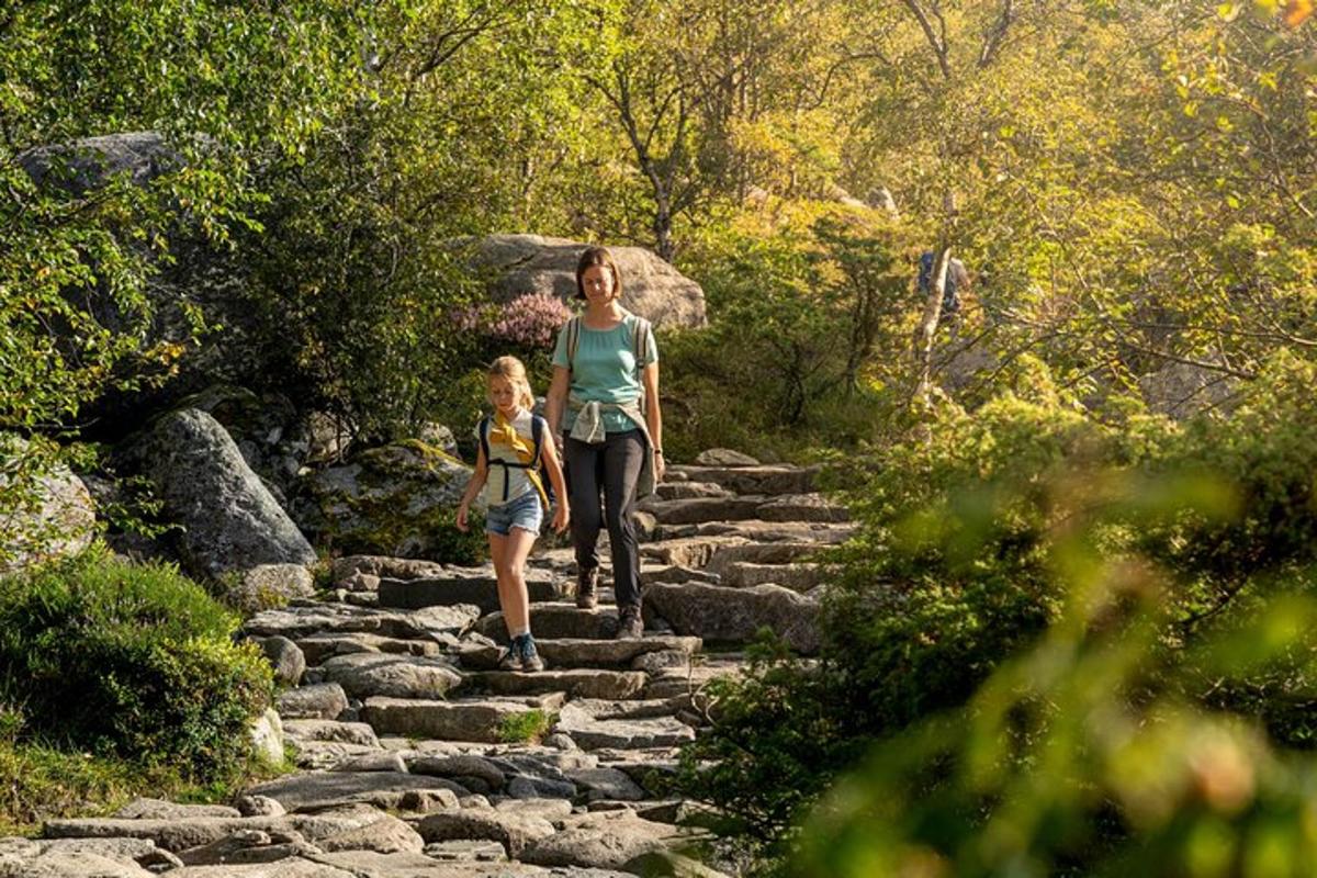 a woman and a child walking up some rocks