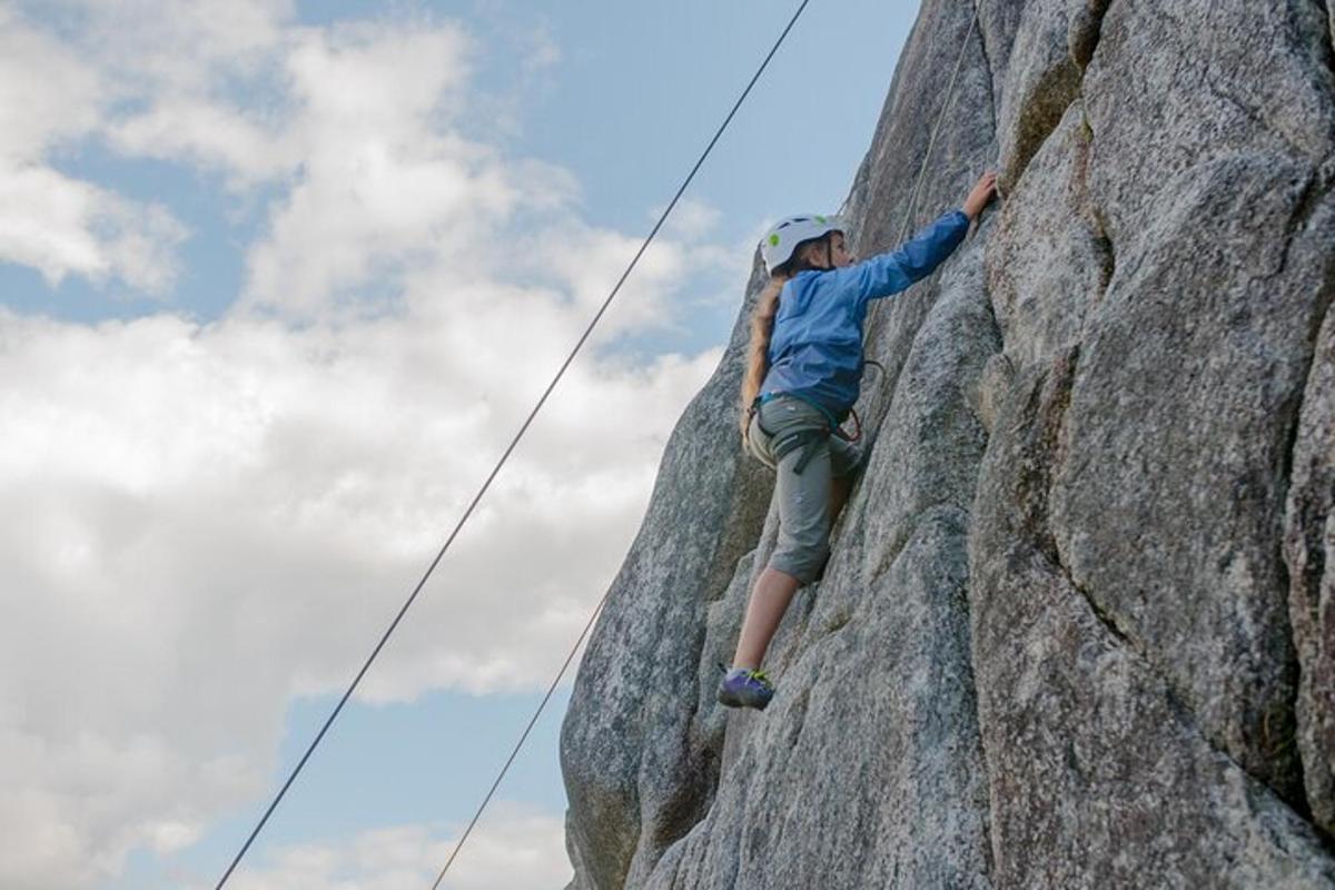 a man is climbing on a rock wall