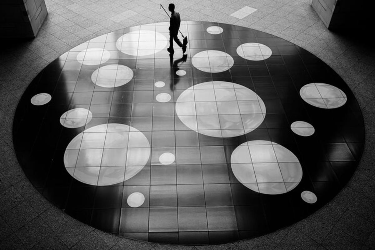 a man walking on a tiled floor in a building