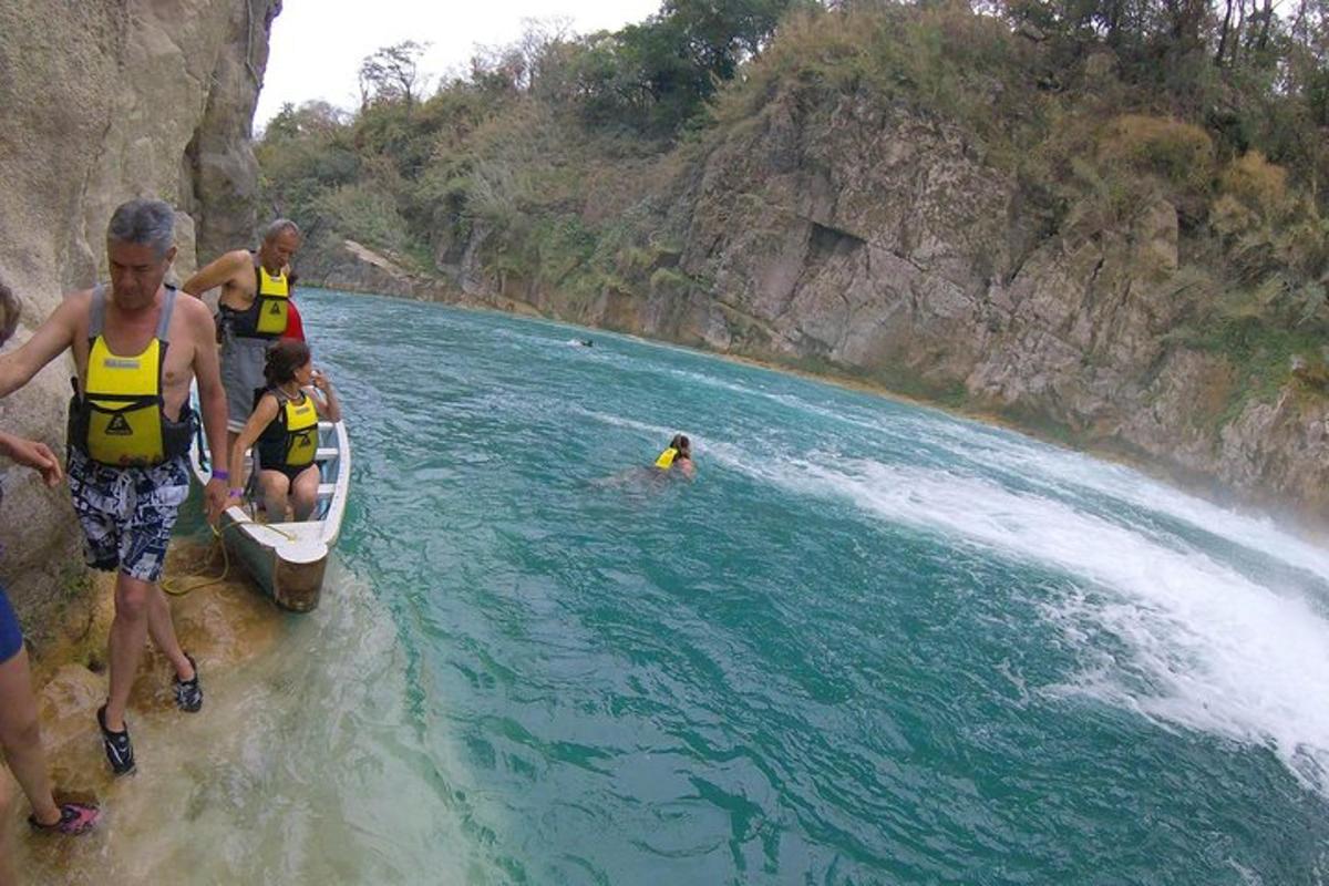 a group of people in a boat in the water
