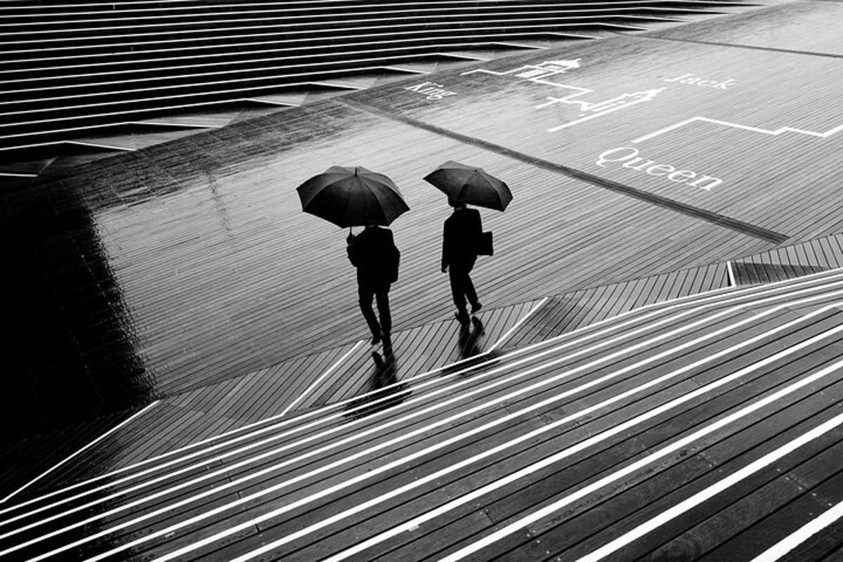 deux personnes marchant dans la rue avec des parapluies