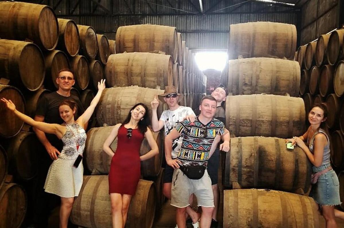 a group of people standing in front of barrels