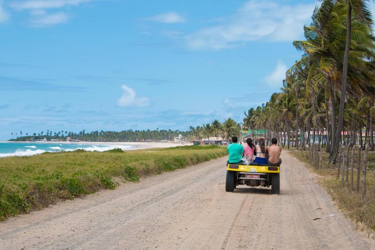 a group of people riding a truck down a dirt road