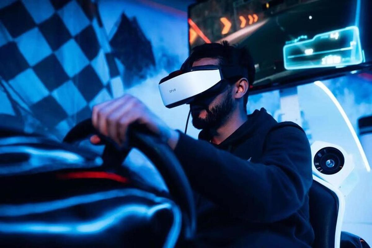 a man wearing a virtual reality helmet sitting in front of a bus
