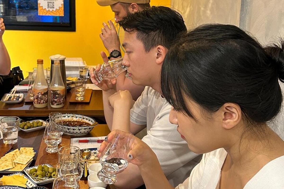 a group of people sitting at a table drinking wine