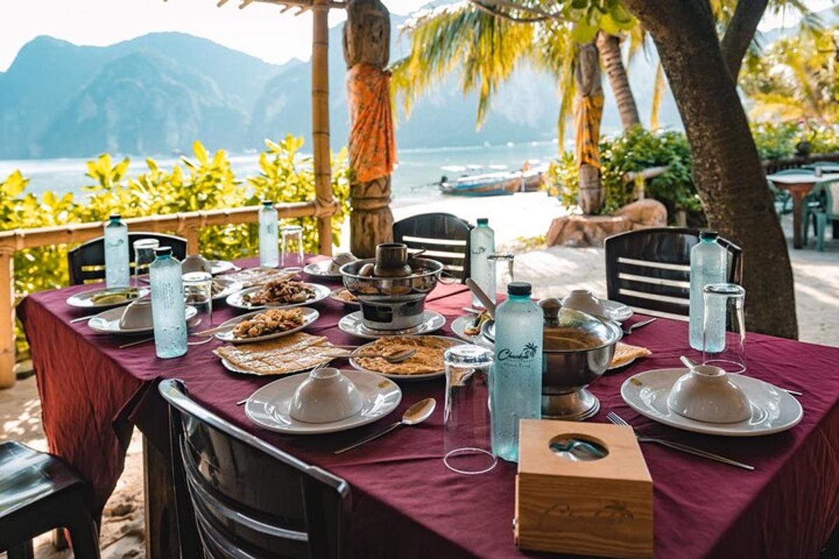 a table with plates of food on a purple table cloth
